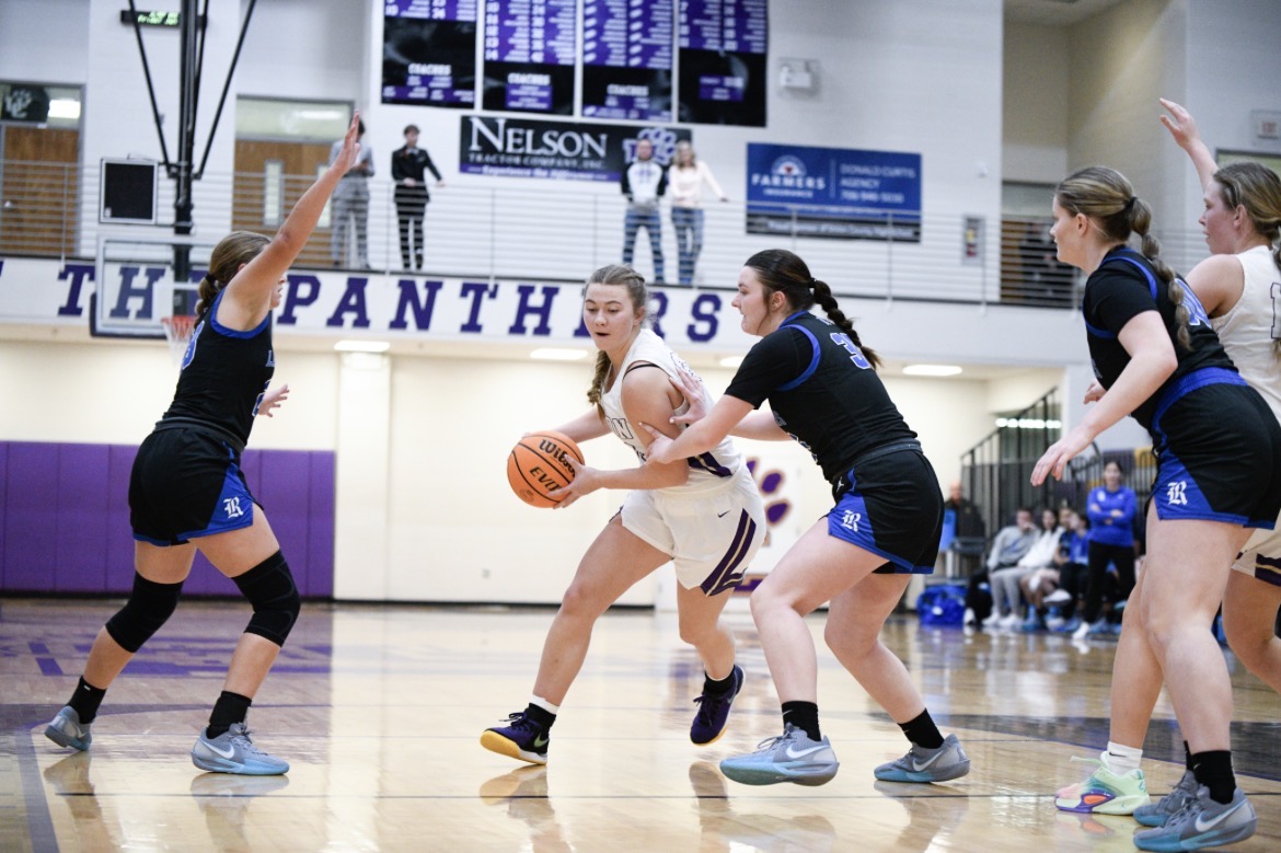 McKenna G Hood driving baseline under the Panthers banner at Union County High School